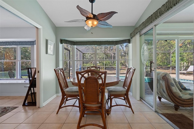 sunroom / solarium with lofted ceiling, a healthy amount of sunlight, and ceiling fan