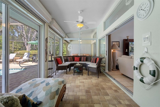 sunroom with lofted ceiling and ceiling fan