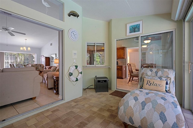 bedroom with vaulted ceiling and a notable chandelier