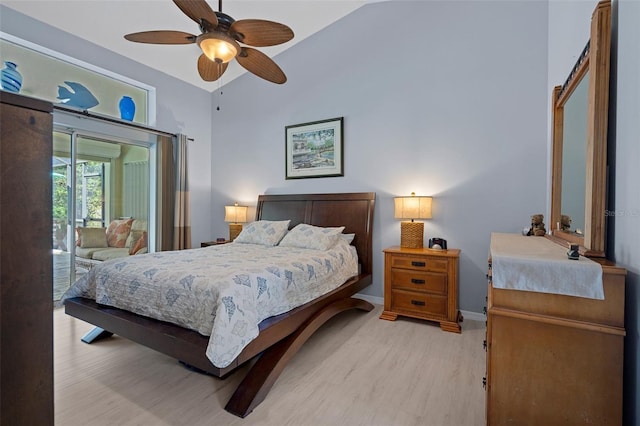 bedroom featuring access to exterior, vaulted ceiling, light hardwood / wood-style floors, and ceiling fan