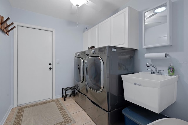 laundry area featuring sink, cabinets, washing machine and clothes dryer, and light tile patterned flooring