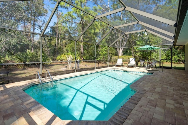 view of pool with a lanai and a patio area