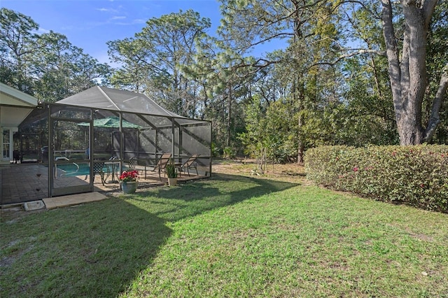 view of yard featuring a patio and a lanai