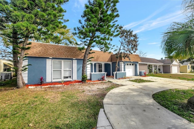 ranch-style house with cooling unit, a garage, and a front yard