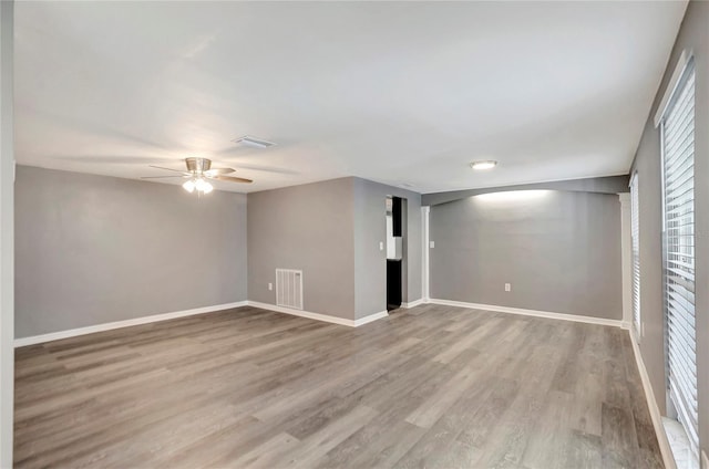 spare room with ceiling fan and light wood-type flooring