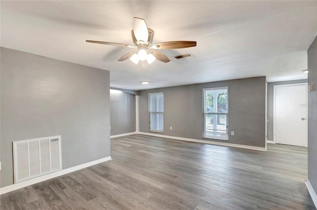 empty room featuring dark hardwood / wood-style floors and ceiling fan