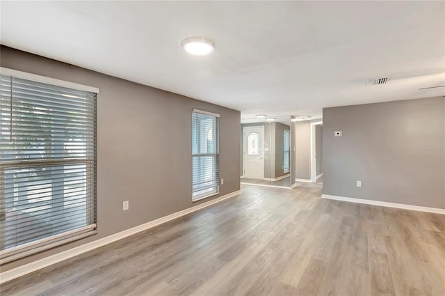 spare room with light hardwood / wood-style flooring