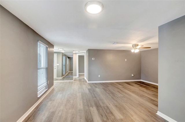 empty room featuring light hardwood / wood-style floors and ceiling fan