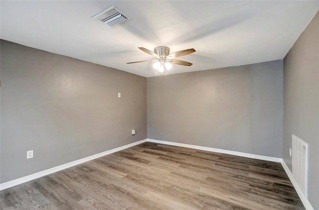 spare room with hardwood / wood-style flooring and ceiling fan