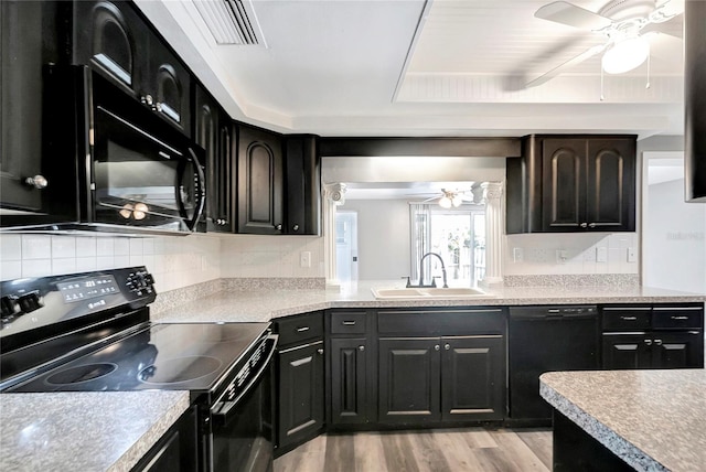 kitchen featuring sink, black appliances, ceiling fan, light hardwood / wood-style floors, and backsplash