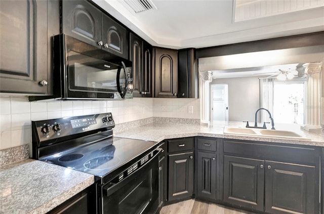 kitchen featuring sink, tasteful backsplash, ceiling fan, light hardwood / wood-style floors, and black appliances