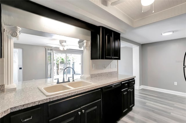 kitchen with decorative columns, black dishwasher, sink, ceiling fan, and light hardwood / wood-style floors