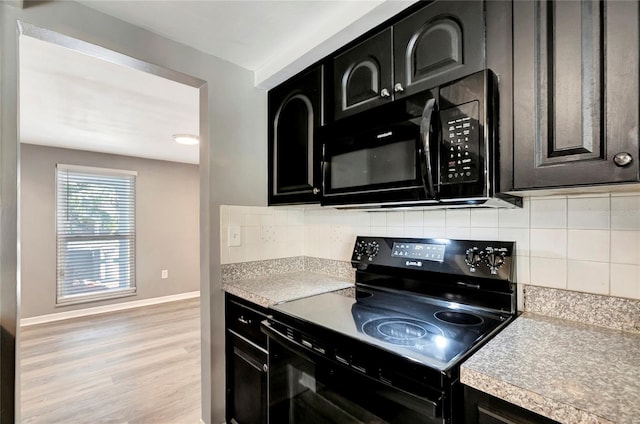 kitchen with decorative backsplash, black appliances, and light hardwood / wood-style floors