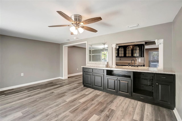 kitchen with decorative backsplash, light hardwood / wood-style flooring, and ceiling fan