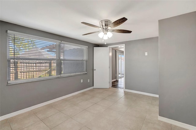 spare room featuring light tile patterned flooring and ceiling fan