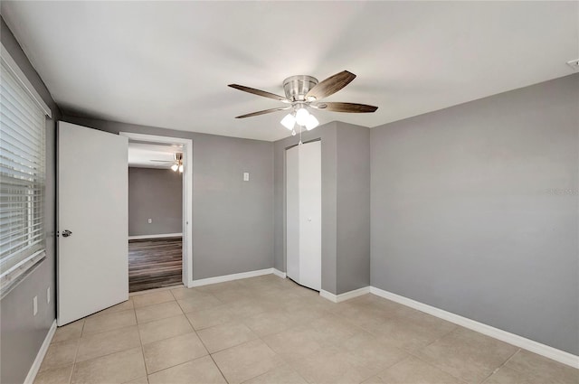 unfurnished bedroom featuring light tile patterned floors, a closet, and ceiling fan