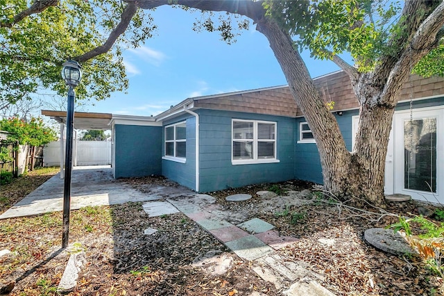 view of side of home with a patio area