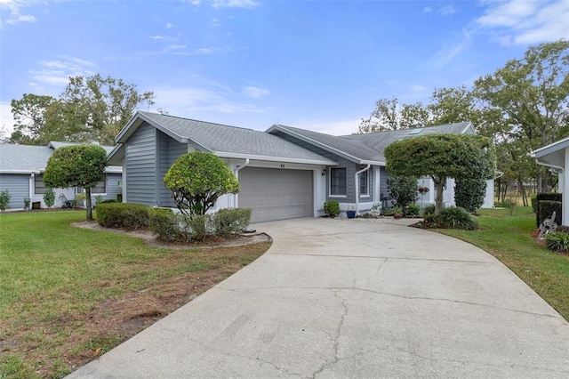 ranch-style house featuring a garage and a front lawn