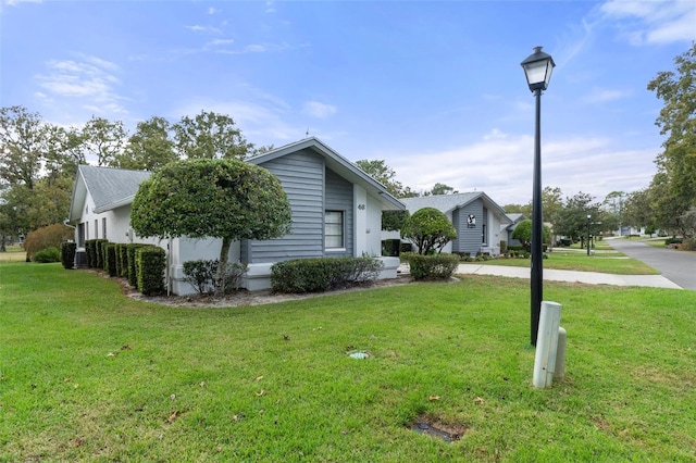 view of side of property featuring a yard