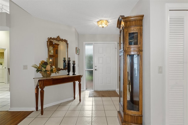 tiled entryway featuring washer / clothes dryer