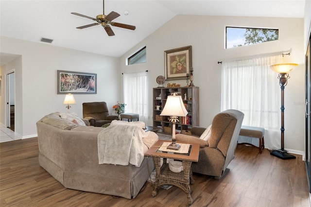 living room featuring hardwood / wood-style flooring, ceiling fan, and high vaulted ceiling