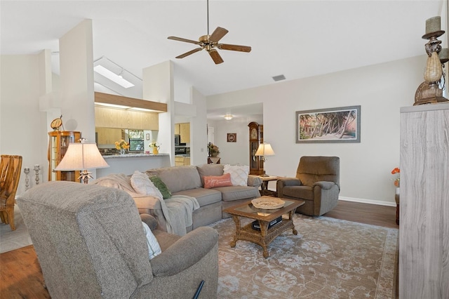 living room featuring high vaulted ceiling, dark hardwood / wood-style floors, and ceiling fan