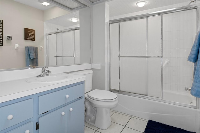 full bathroom featuring enclosed tub / shower combo, tile patterned floors, toilet, and vanity