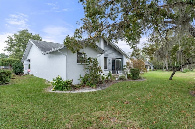 view of side of home featuring a yard