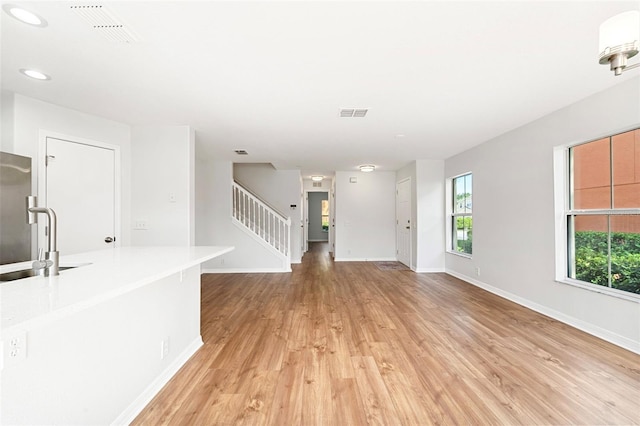 interior space with sink and light wood-type flooring