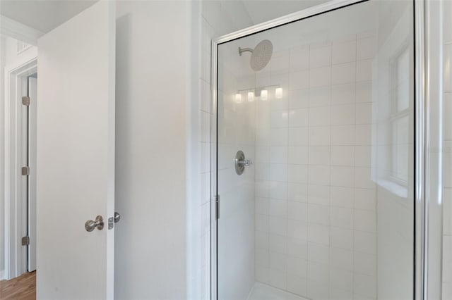 bathroom with a shower with door