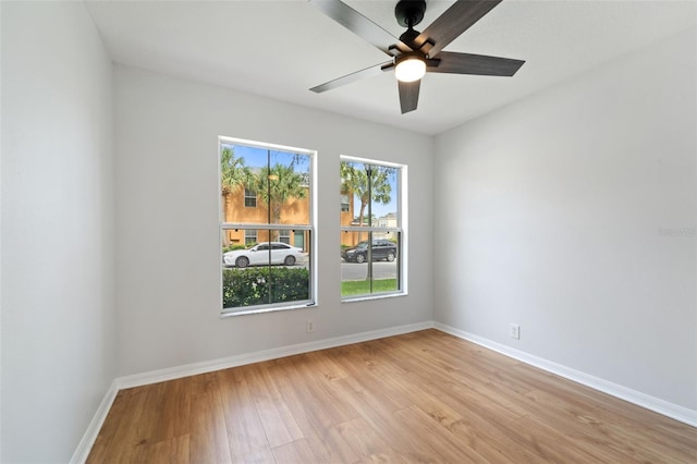 unfurnished room with ceiling fan and light wood-type flooring