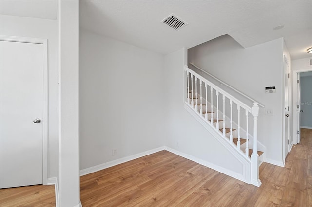 stairway featuring wood-type flooring