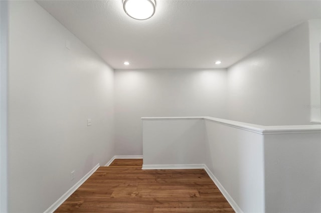 hallway with dark hardwood / wood-style floors