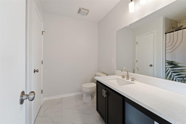 bathroom featuring vanity and toilet