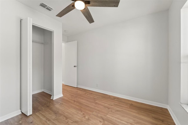 unfurnished bedroom with ceiling fan, a closet, and light hardwood / wood-style flooring