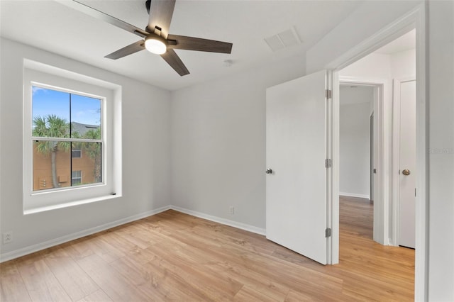 unfurnished room with ceiling fan and light wood-type flooring