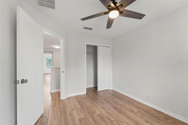 unfurnished bedroom featuring a closet, ceiling fan, and light wood-type flooring