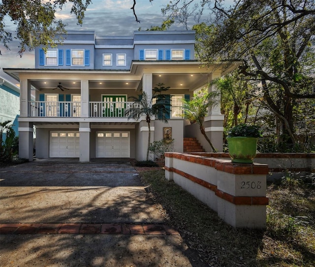 view of front facade with driveway, a garage, stairs, and stucco siding