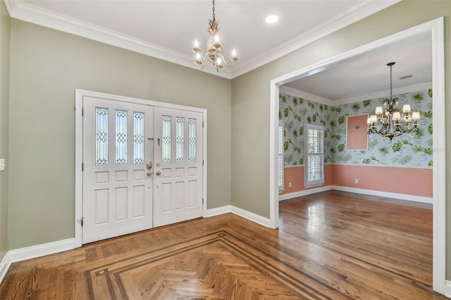 entrance foyer with wallpapered walls, baseboards, ornamental molding, and a notable chandelier