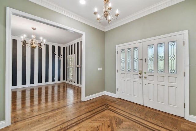 foyer with ornamental molding, plenty of natural light, baseboards, and an inviting chandelier