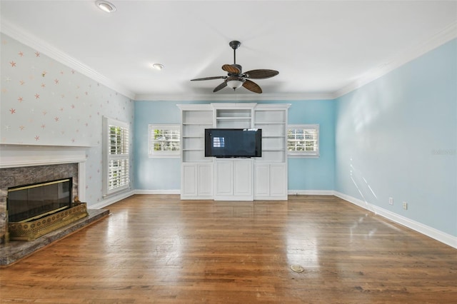 unfurnished living room featuring ornamental molding, a high end fireplace, and baseboards