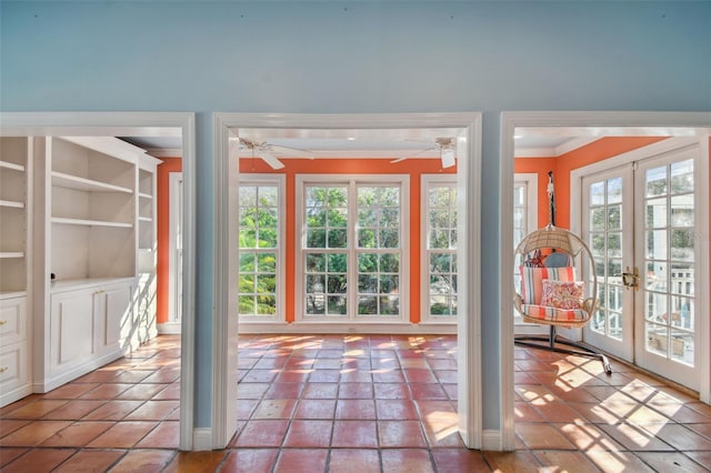 doorway with ornamental molding, french doors, and a ceiling fan