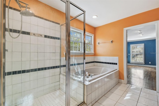 full bathroom featuring a garden tub, tile patterned flooring, baseboards, and a shower stall