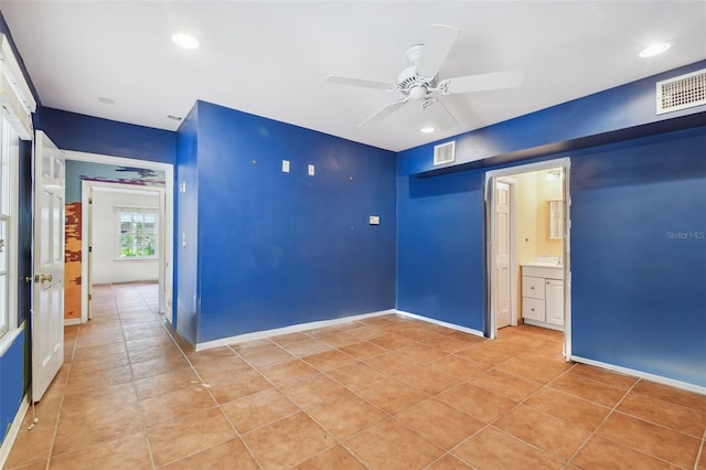 empty room featuring light tile patterned floors, visible vents, and recessed lighting