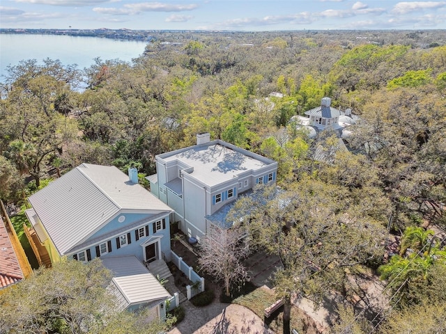 drone / aerial view featuring a water view and a wooded view