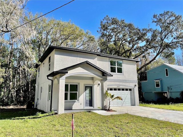 view of front property featuring a garage and a front lawn