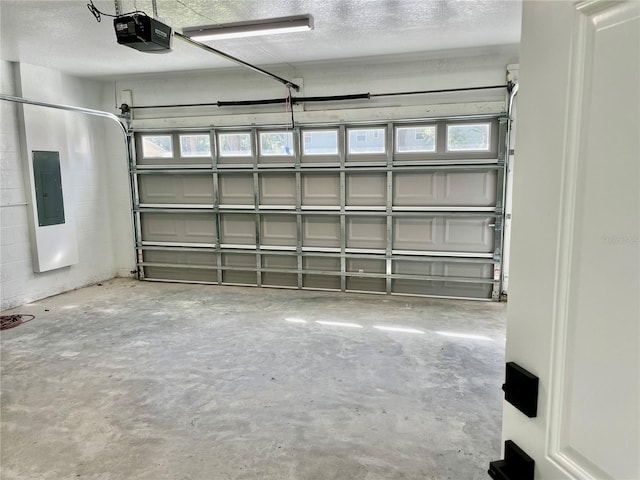 garage with a garage door opener and electric panel