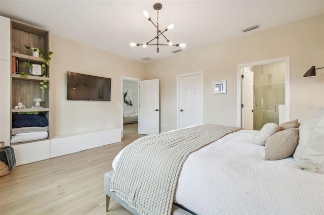 bedroom featuring an inviting chandelier and light hardwood / wood-style flooring