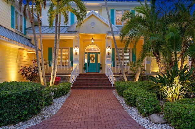 entrance to property featuring stucco siding and a porch