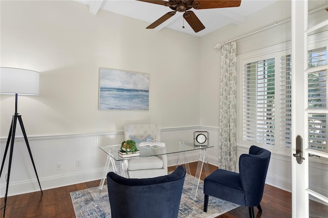 home office featuring beam ceiling, wainscoting, ceiling fan, and wood finished floors